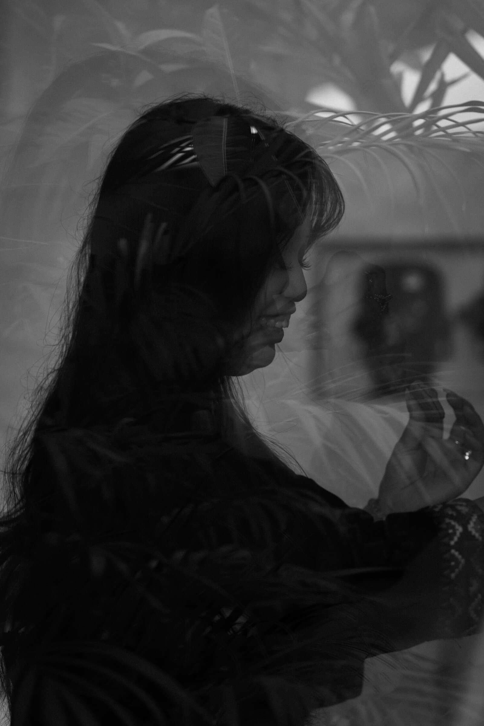 Double-exposure portrait with leaves, black and white