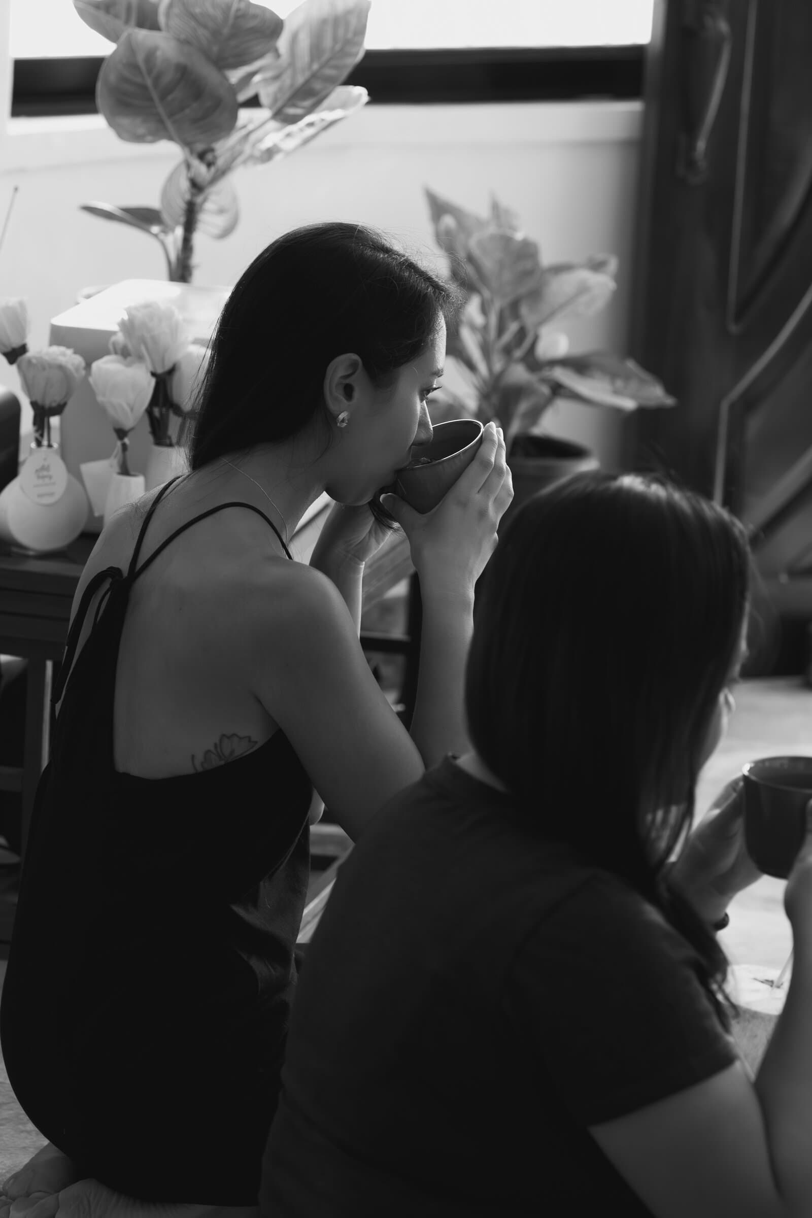 Friends sharing tea, black and white