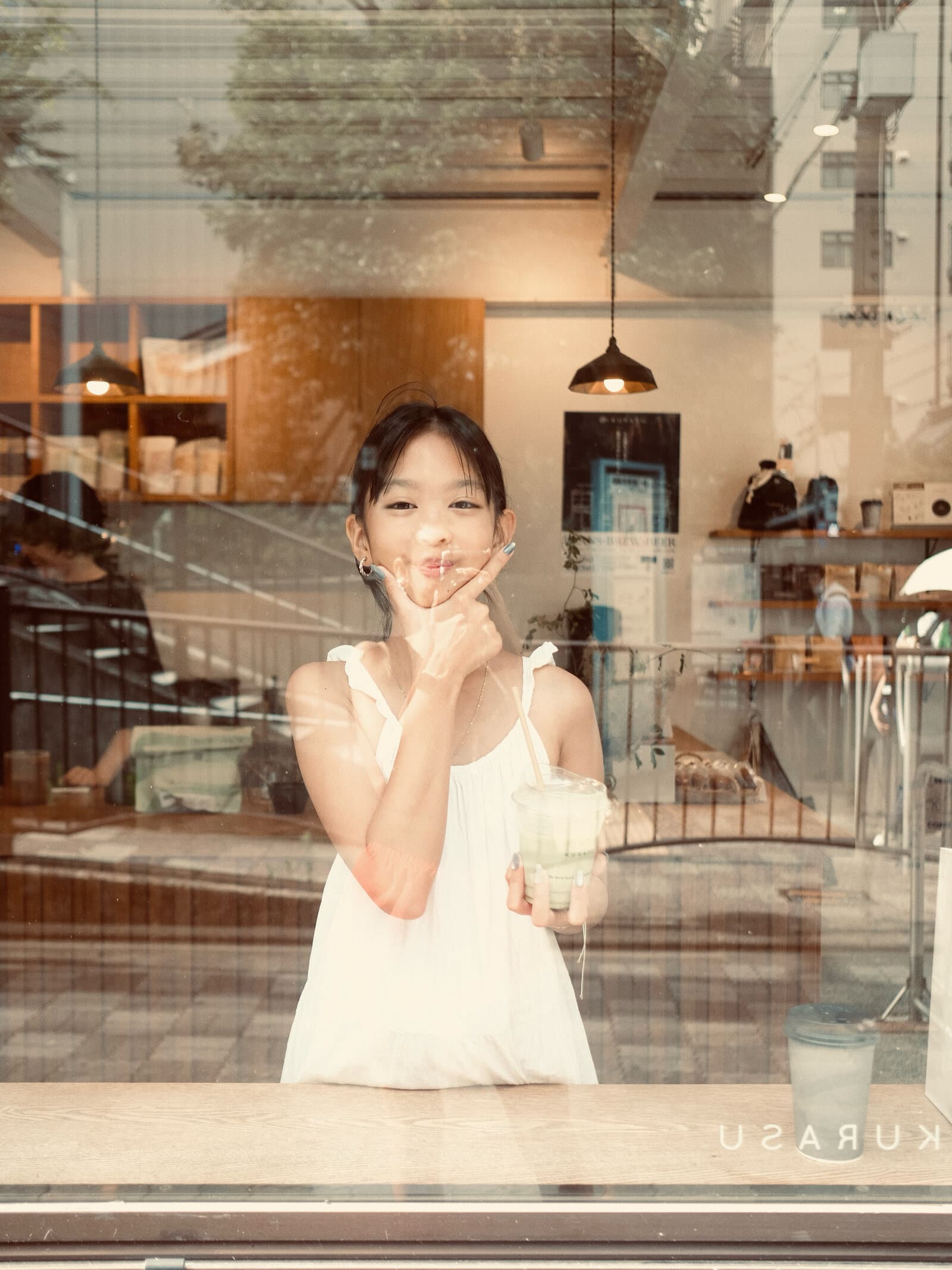 Candid portrait through a café window
