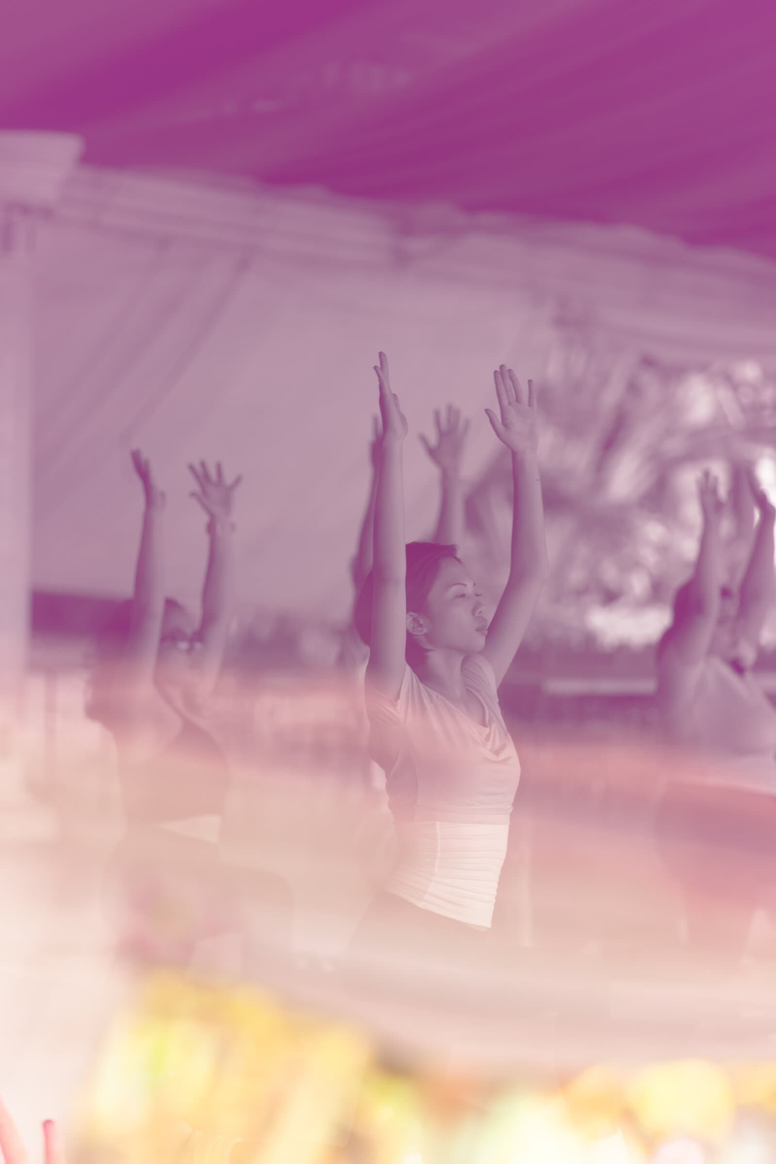 Hands raised together at an outdoor session